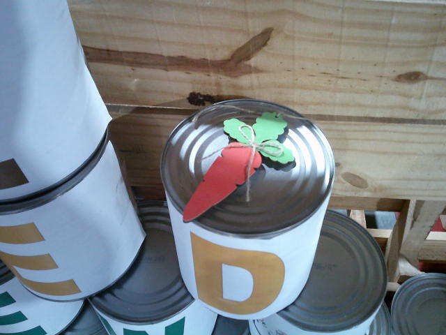 Carrot decoration on top of a can that is covered with a paper that says d.